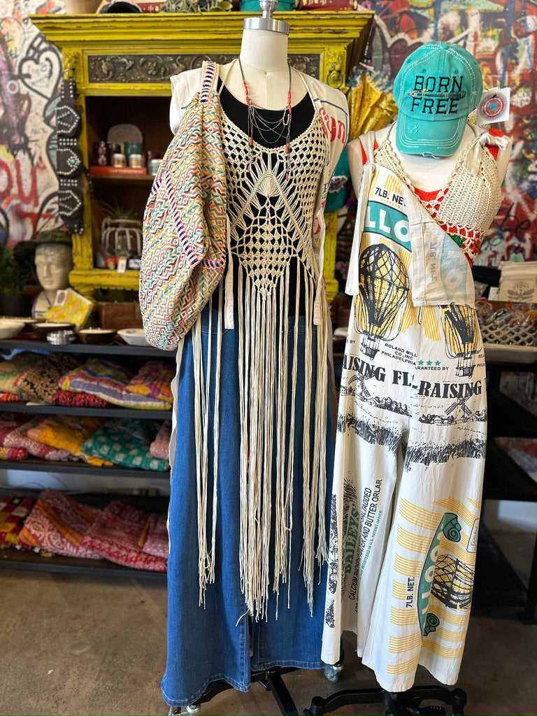 Trestles Clothing Company cream crochet maxi vest with long fringe layered over a blue denim outfit on a mannequin
