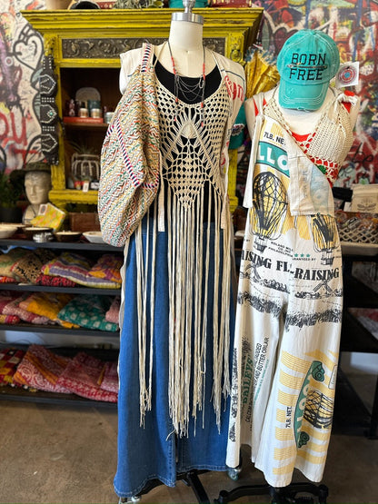 Trestles Clothing Company cream crochet maxi vest with long fringe layered over a blue denim outfit on a mannequin
