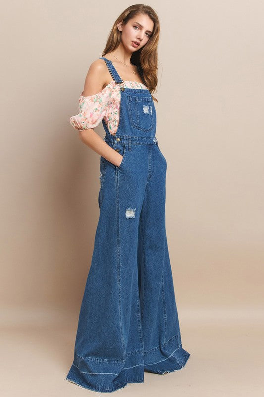 Trestles Clothing Company denim overalls with extreme bell bottoms and distressed details worn by a model