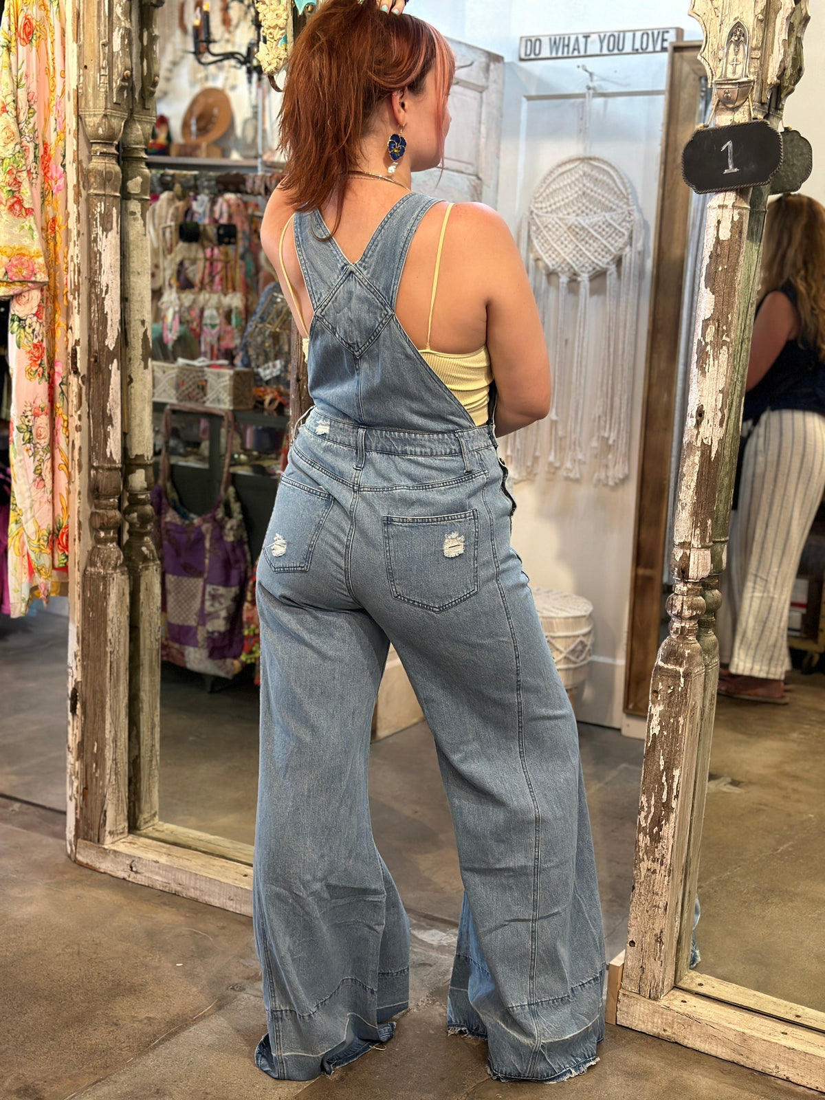 Trestles Clothing Company light wash denim overalls with extreme bell bottoms and distressed back pockets
