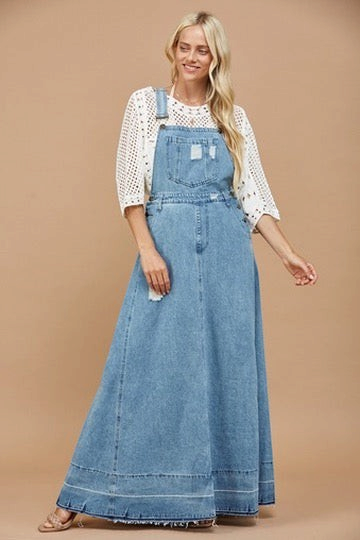 Trestles Clothing Company 70s inspired light wash denim maxi overall dress with a distressed bib and flared skirt.