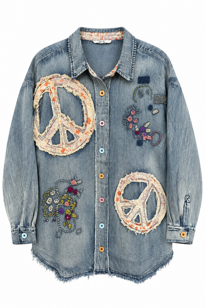 Trestles Clothing Company oversized denim shirt with peace sign appliqués, floral embroidery, and mismatched buttons.