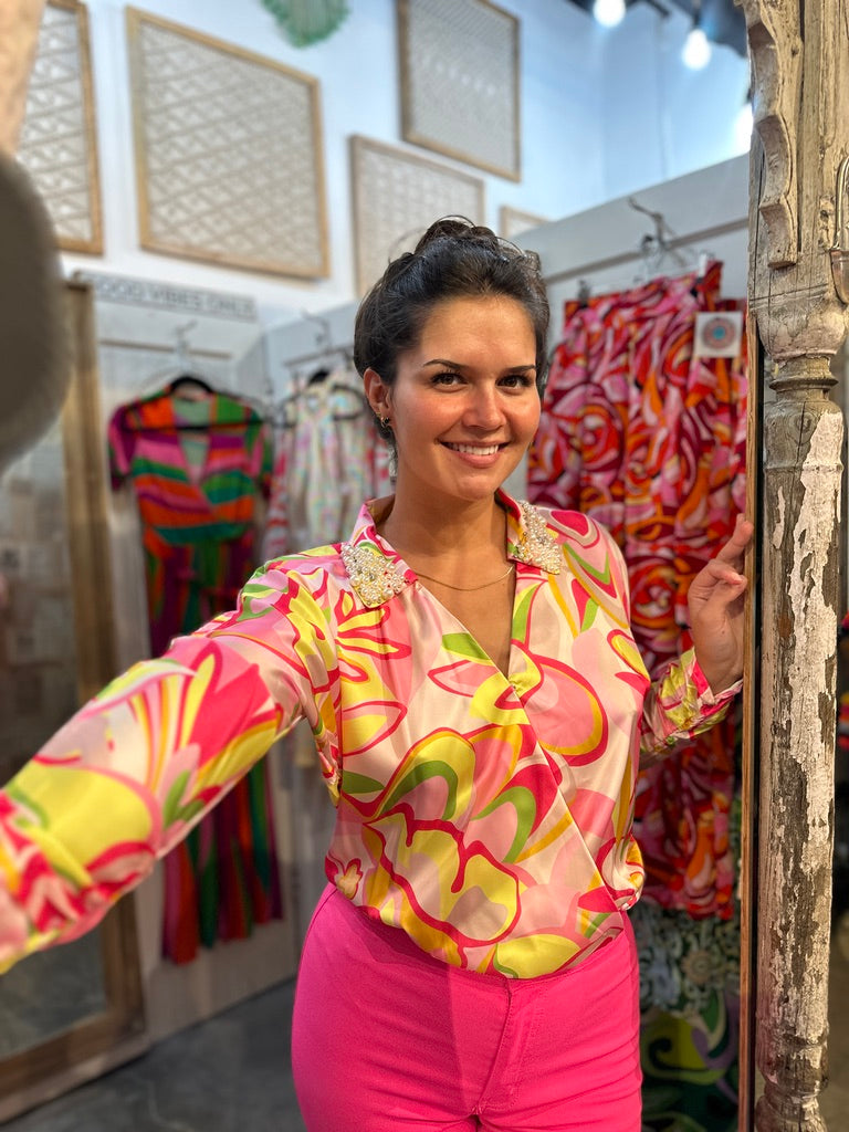 Trestles Clothing Company disco bodysuit with long sleeves, vibrant floral print, and pearl-embellished collar