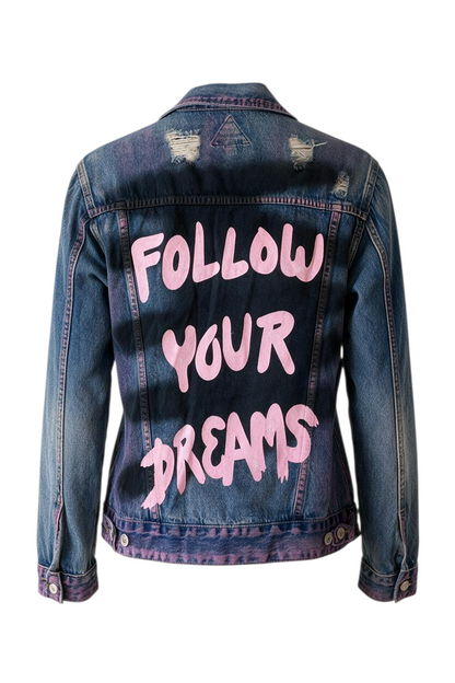 Trestles Clothing Company distressed denim jacket with hand-painted pink Follow Your Dreams text on the back
