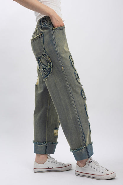 Trestles Clothing Company distressed wide-leg denim jeans with peace sign patches and elastic waistband