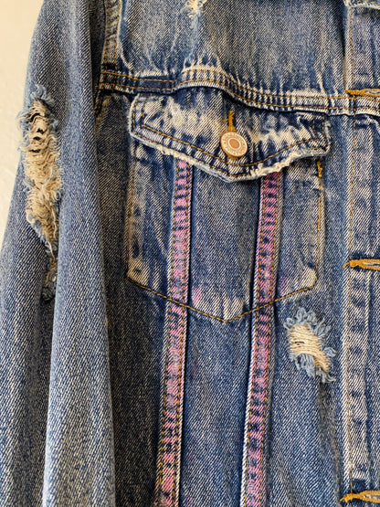 Trestles Clothing Company distressed blue denim jacket with hand-painted pink spray paint accents on the pocket.