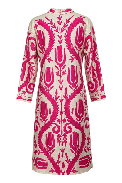 Trestles Clothing Company cotton duster featuring vibrant hot pink floral embroidery on a cream canvas background.