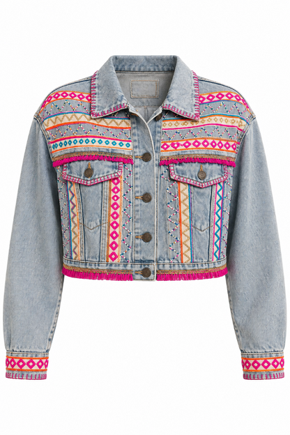 Trestles Clothing Company cropped denim jacket with vibrant hand-embroidered Aztec motifs, pink accents, and tassels.