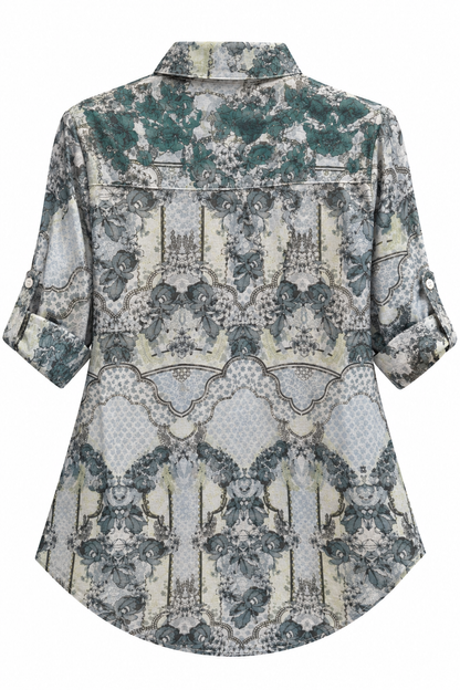 Back view of a Trestles Clothing Company floral cotton blouse with a collared neckline and rolled sleeves.
