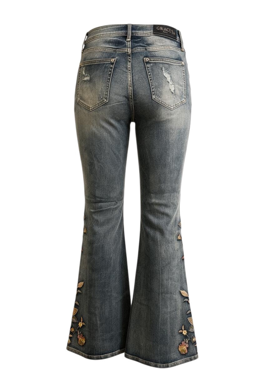 Trestles Clothing Company washed blue denim jeans with floral embroidery and distressed back pockets