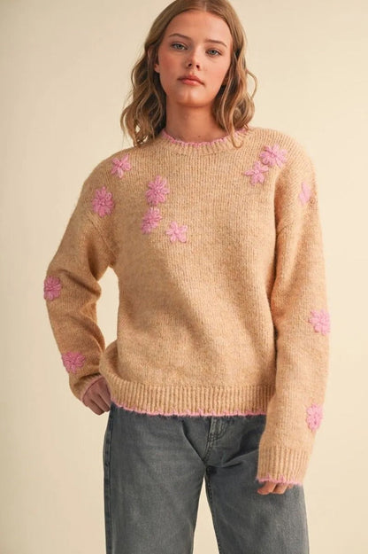 Trestles Clothing Company beige knit sweater with pink floral embroidery and scalloped trim worn by a blonde model