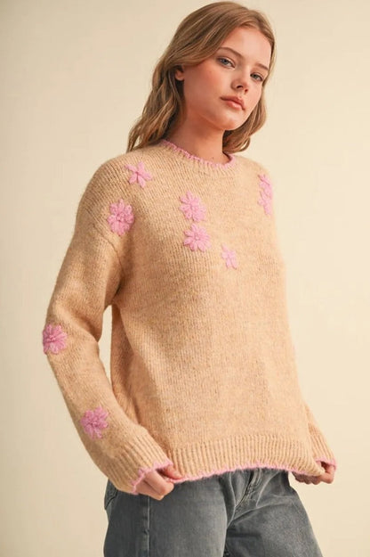 Trestles Clothing Company beige knit sweater with pink floral embroidery and scalloped trim worn by a blonde model