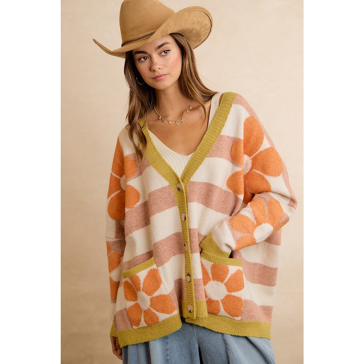 Trestles Clothing Company oversized knit cardigan with retro orange floral pattern, stripes, and front pockets.