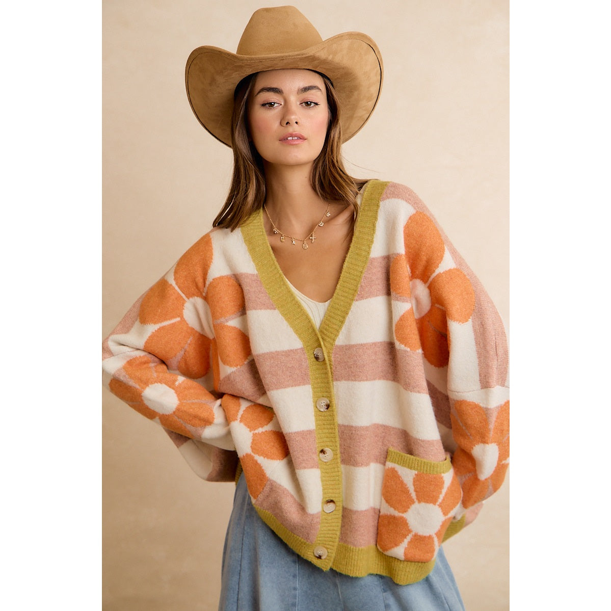 Trestles Clothing Company oversized knit cardigan with orange floral pattern, striped design, and V-neck on a model.