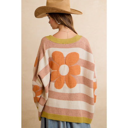 Trestles Clothing Company oversized knit cardigan with retro floral pattern and stripes worn with a tan hat
