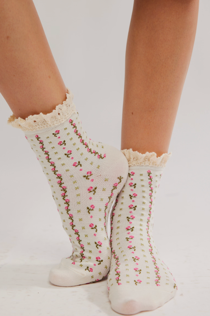 Trestles Clothing Company waffle knit crew socks with pink floral print and dainty ruffled trim on a model
