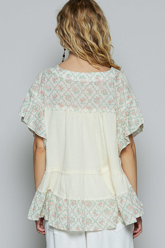 Back view of Trestles Clothing Company ruffle sleeve top in cream double gauze with floral print trim and tiered hem.