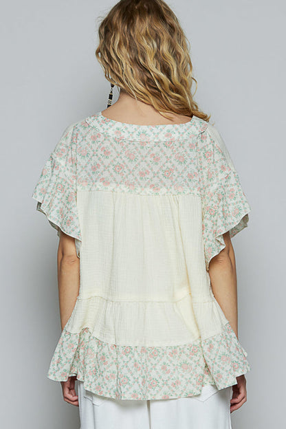 Back view of Trestles Clothing Company ruffle sleeve top in cream double gauze with floral print trim and tiered hem.