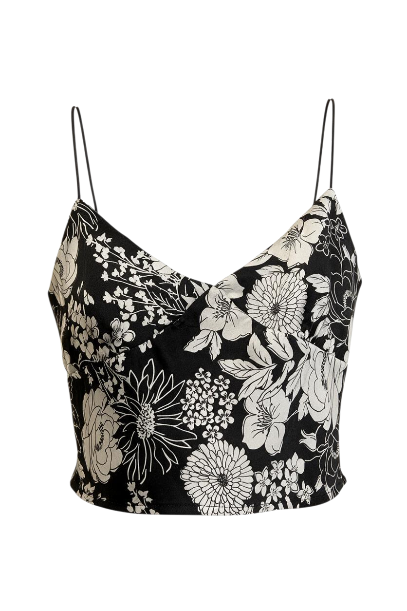 Trestles Clothing Company black and white floral satin crop top with thin bungee straps on an orange hanger.