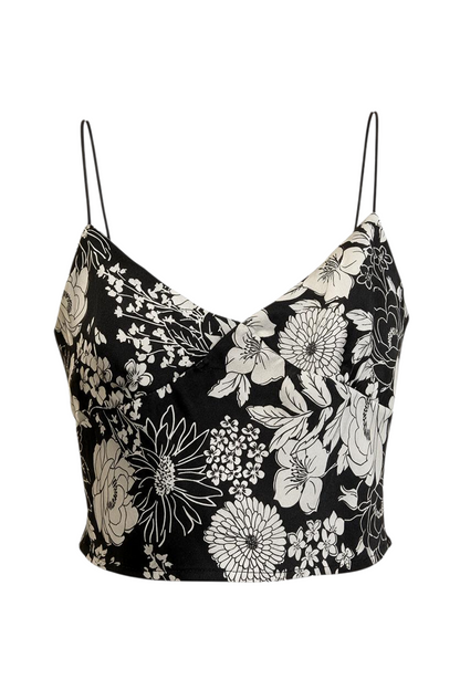 Trestles Clothing Company black and white floral satin crop top with thin bungee straps on an orange hanger.