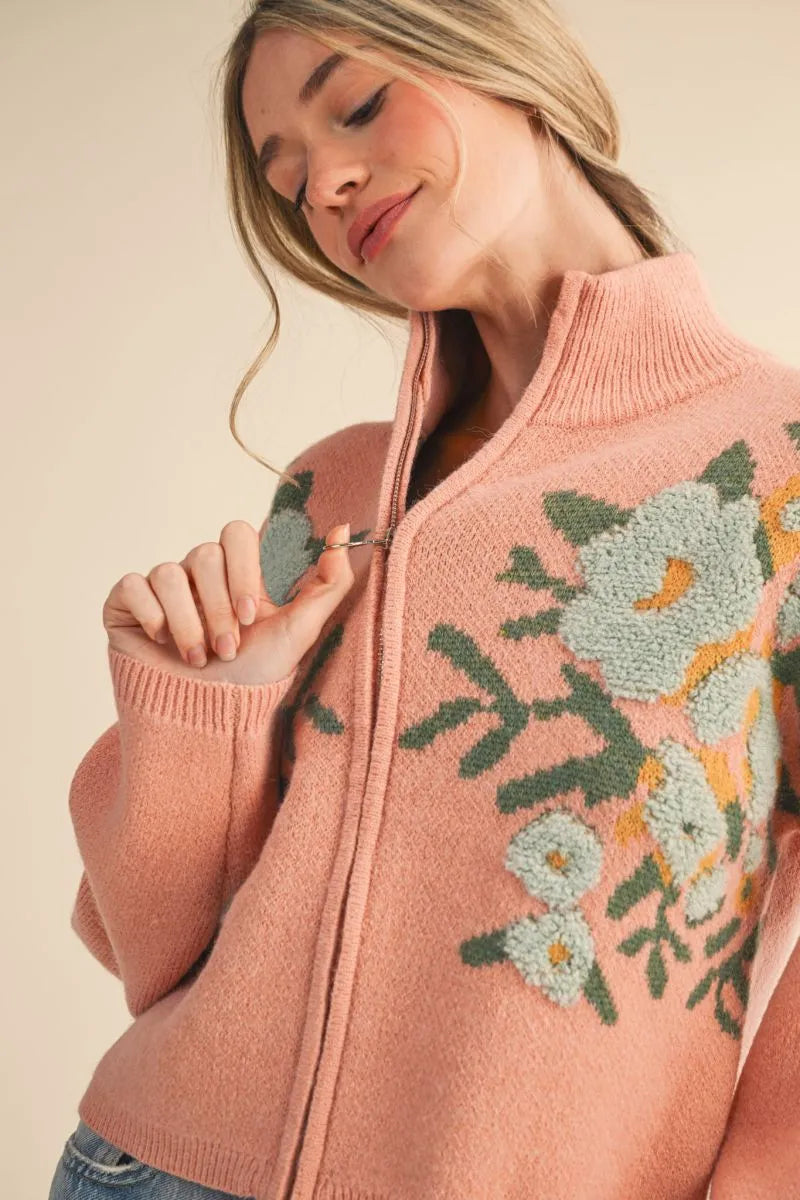 Trestles Clothing Company floral zip up sweater in soft pink knit with puff sleeves and a stand collar