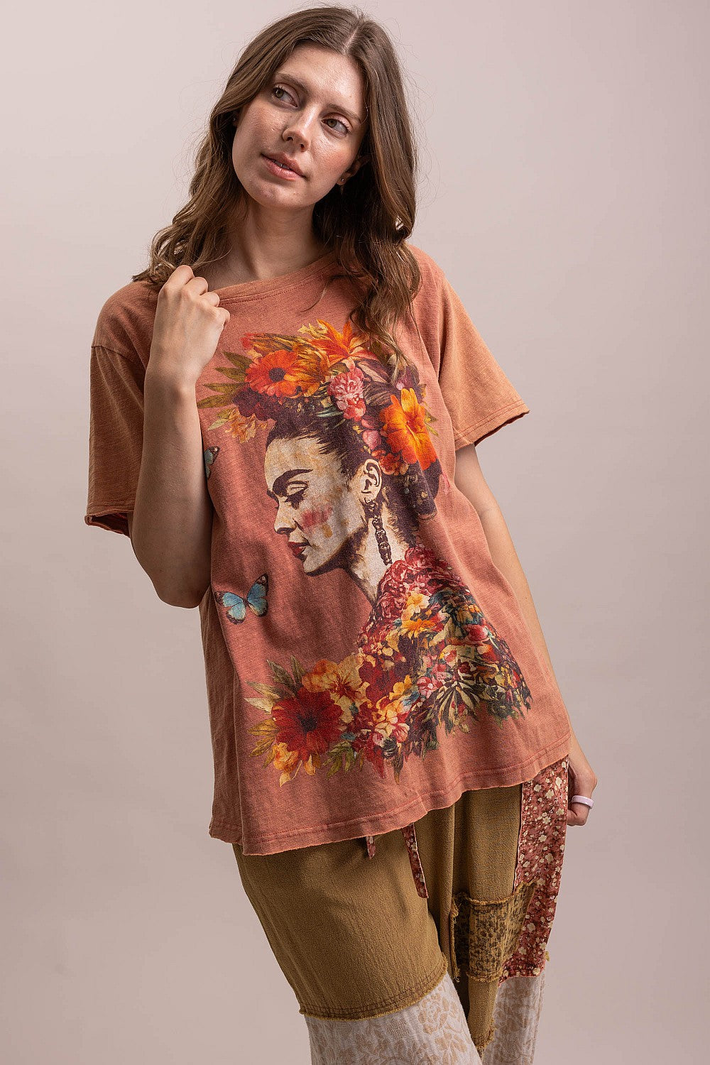 Trestles Clothing Company vintage washed cotton graphic tee featuring a Frida Kahlo floral print on a rust orange shirt