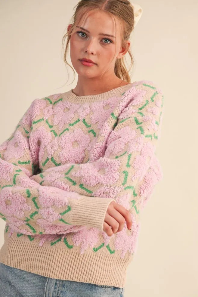 Trestles Clothing Company fuzzy pink floral knit sweater with a round neck and ribbed trim on a model