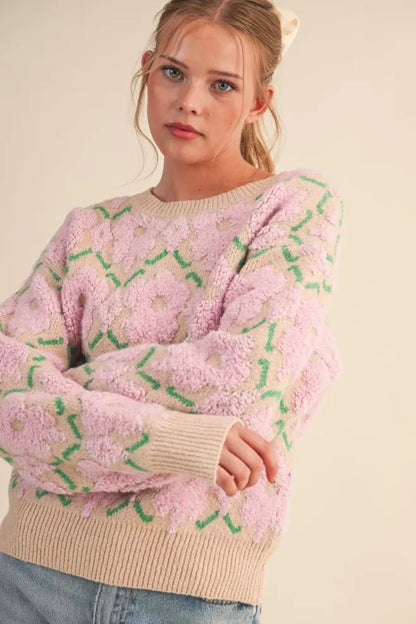 Trestles Clothing Company fuzzy pink floral knit sweater with a round neck and ribbed trim on a model