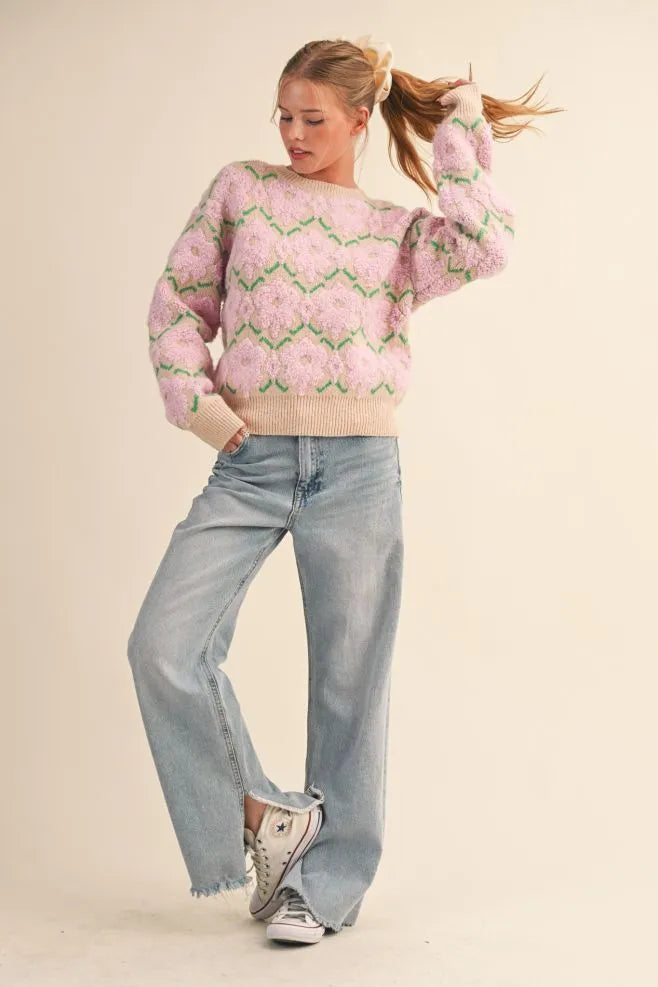 Trestles Clothing Company fuzzy pink and green floral knit sweater with a relaxed fit and ribbed trim on a model.