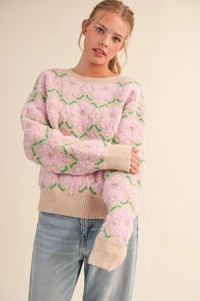 Trestles Clothing Company fuzzy floral knit sweater with pink flowers, green stems, and beige ribbed trim on a model