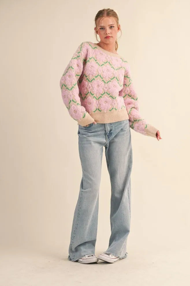 Trestles Clothing Company fuzzy floral knit sweater with pink flowers, drop shoulders, and ribbed trim on a model.
