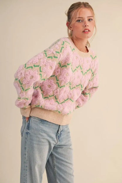 Trestles Clothing Company fuzzy floral knit sweater with pink textured flowers and beige ribbed trim on a model