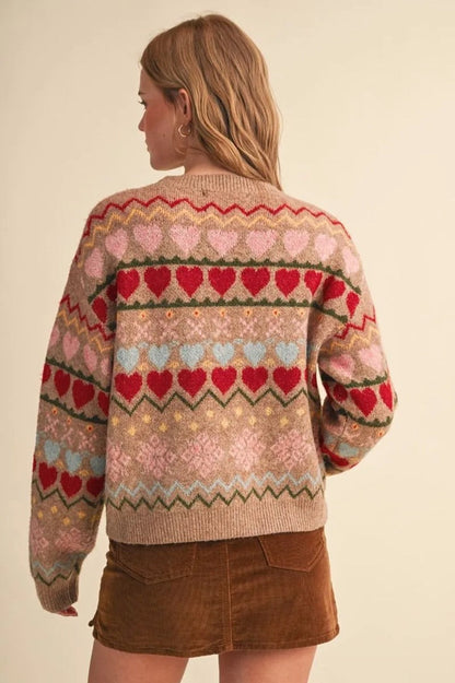 Back view of Trestles Clothing Company Gingerbread Hearts Sweater with colorful geometric heart pattern on beige knit
