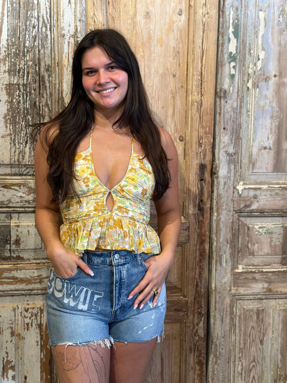 Trestles Clothing Company Gold T Garden v-neck halter top with yellow floral print, smocked back, and peplum ruffle.