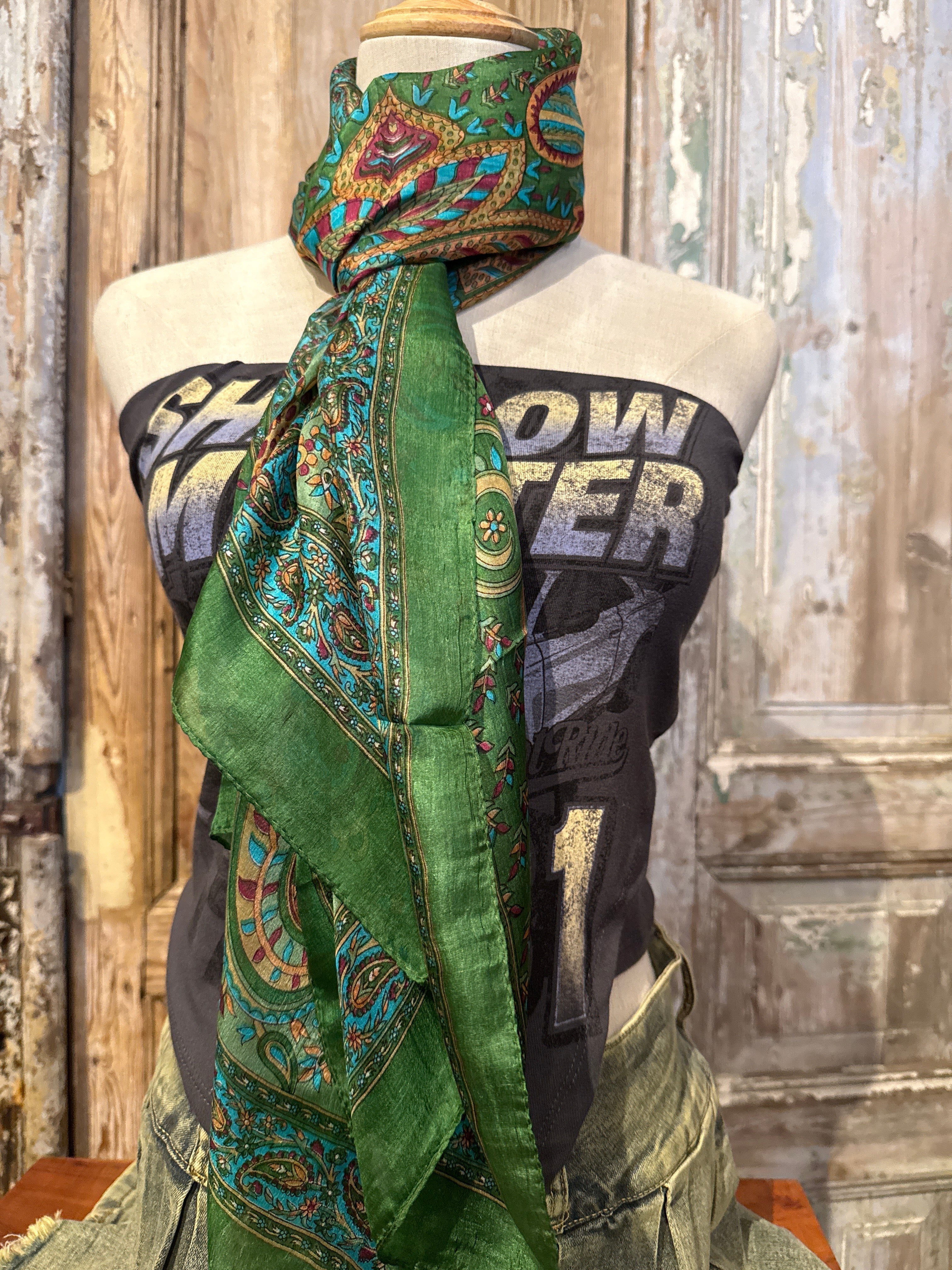 Trestles Clothing Company green silk boho scarf with vibrant paisley and floral patterns draped on a mannequin