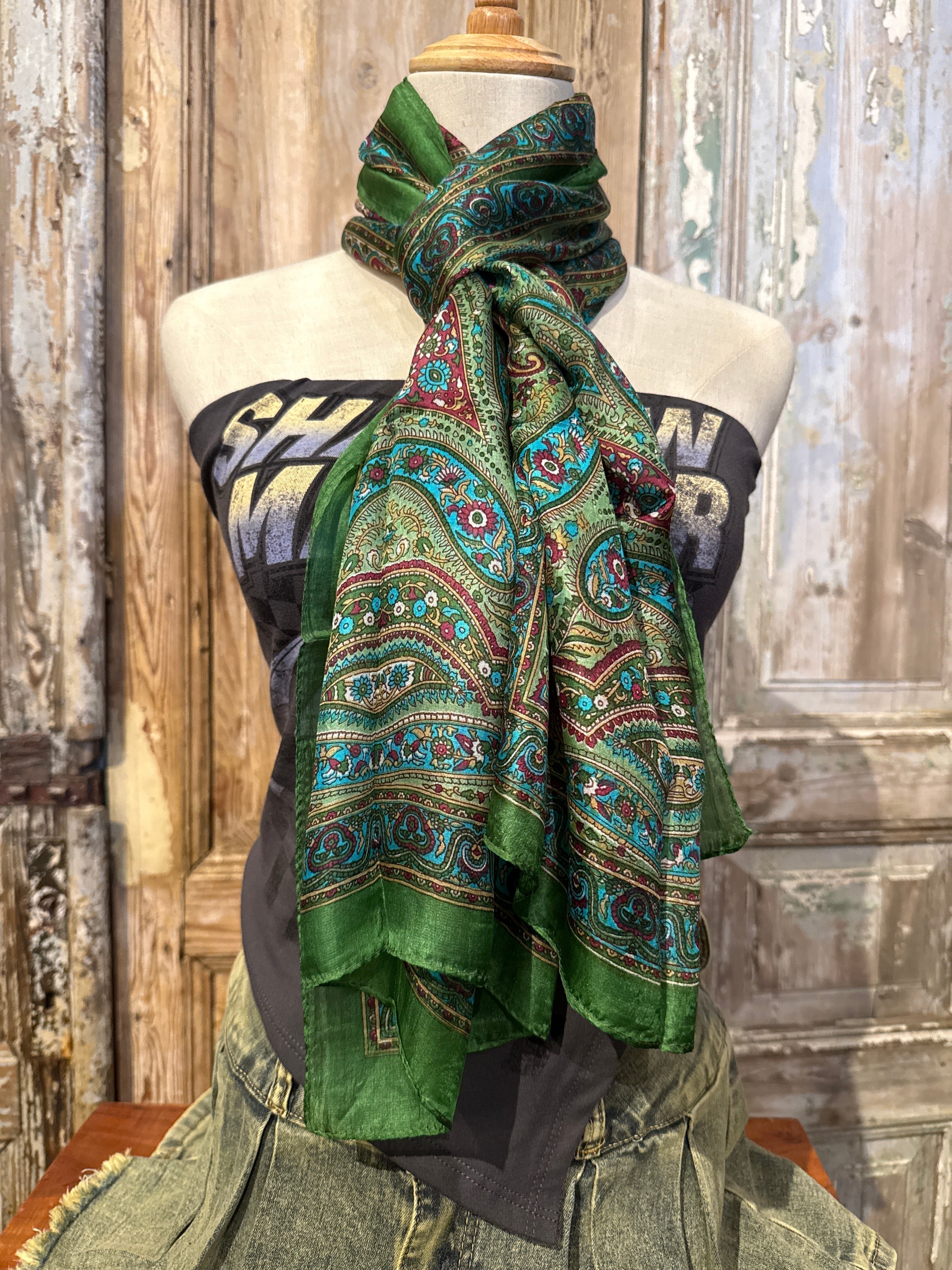 Trestles Clothing Company green silk boho scarf with vibrant paisley print draped on a mannequin