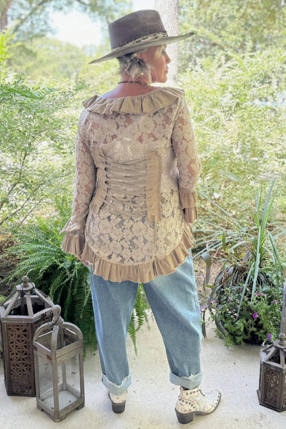 Trestles Clothing Company lace jacket with back corset ties, ruffled hem, and sleeves worn by a woman in a hat
