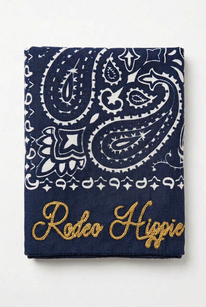 Trestles Clothing Company navy blue stonewashed bandana with white paisley print and gold Rodeo Hippie embroidery