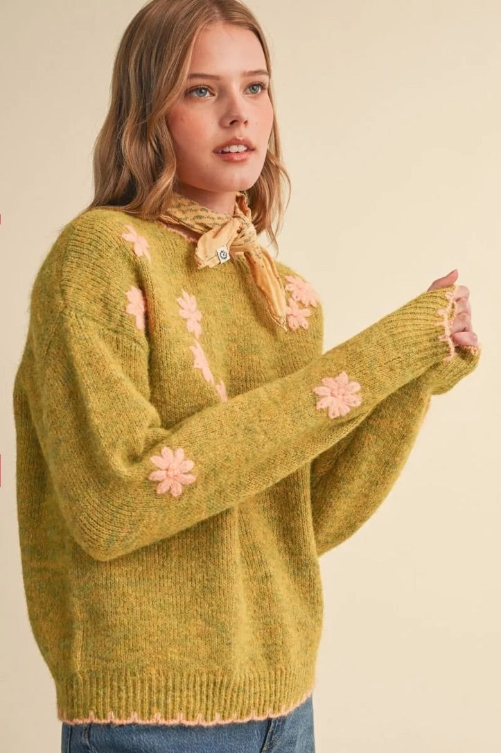Trestles Clothing Company olive green knit sweater with pink floral embroidery, scalloped edges, and drop shoulders.