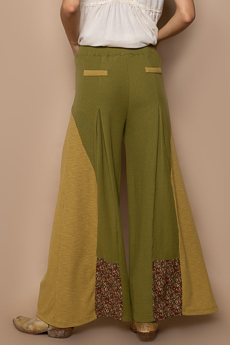 Trestles Clothing Company olive green knit flare pants with floral contrast panels and faux back pockets