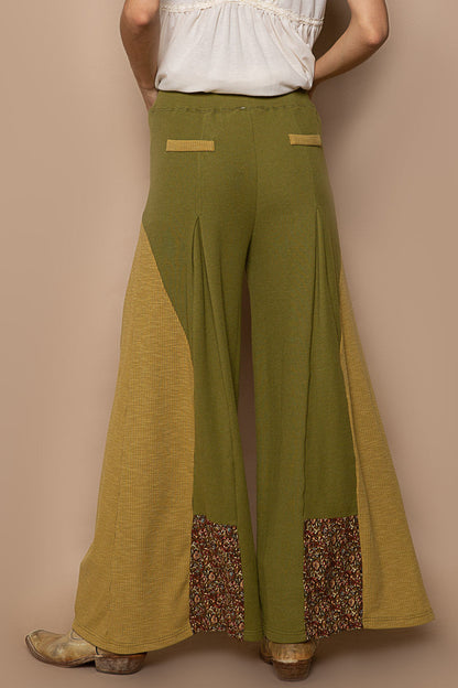 Trestles Clothing Company olive green knit flare pants with floral contrast panels and faux back pockets