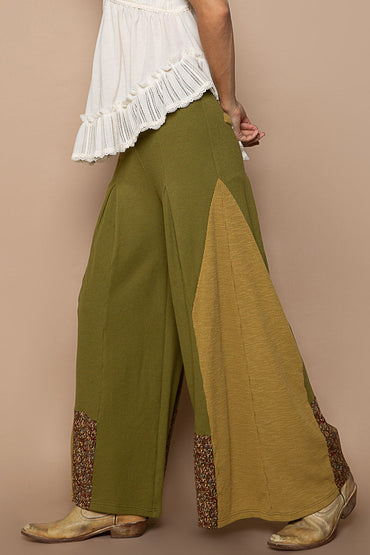 Trestles Clothing Company olive green knit flare pants with contrast floral panels and retro boho style
