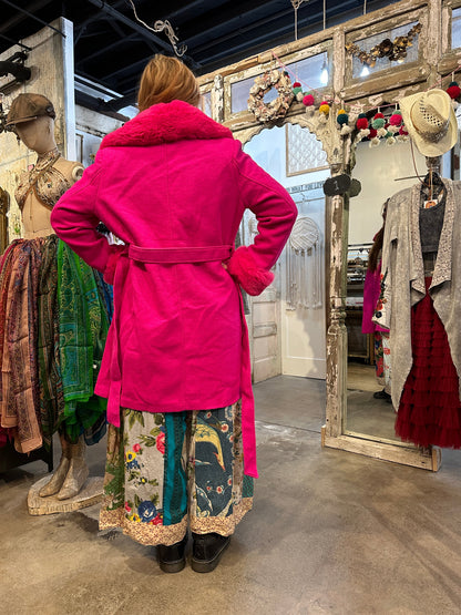 Trestles Clothing Company bright pink coat with removable faux fur collar and cuffs, worn with a floral maxi skirt.