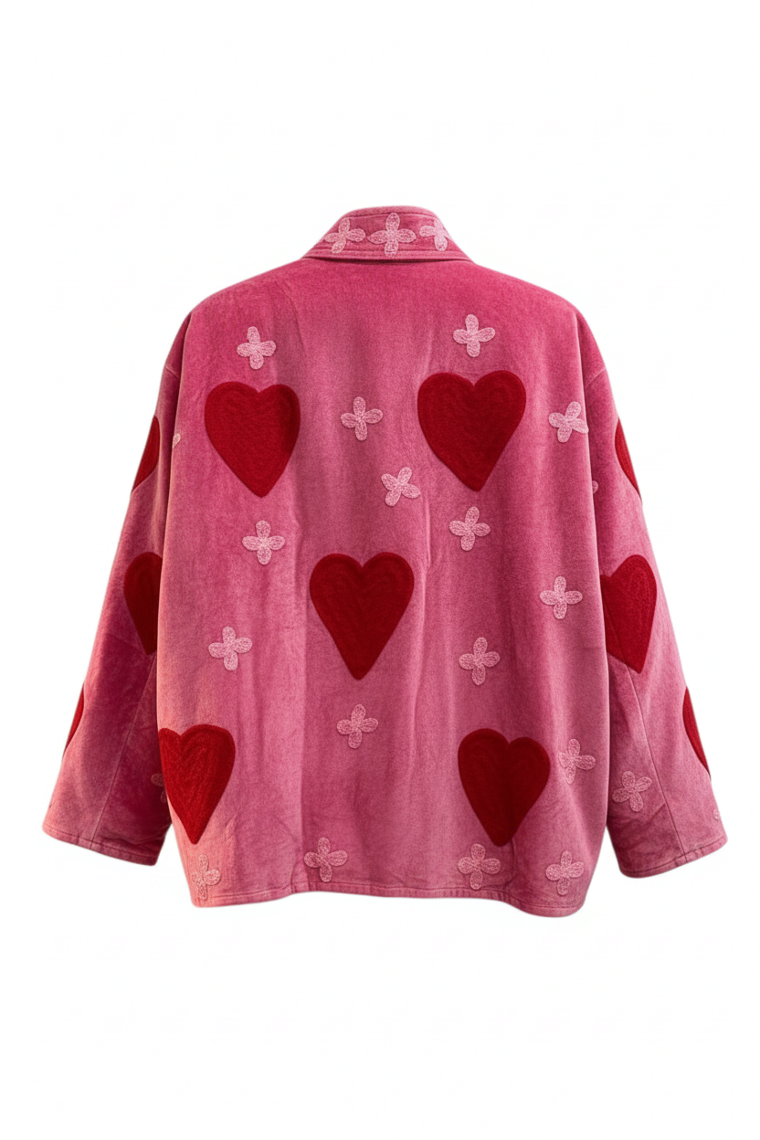 Back view of Trestles Clothing Company hot pink cotton velvet jacket featuring red heart and floral embroidery.