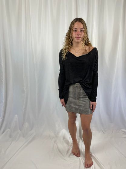 Model wearing Trestles Clothing Company micro plaid mini skirt with denim back and black long sleeve top