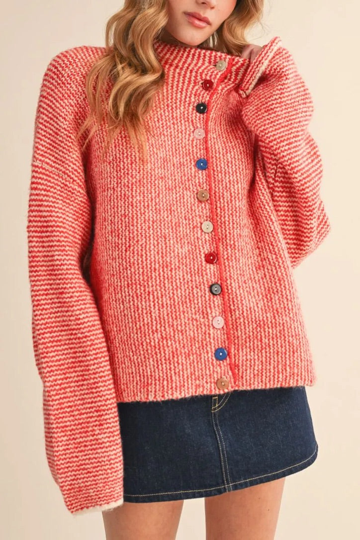 Model wearing a Trestles Clothing Company cozy red and white striped knit sweater with unique mismatched buttons