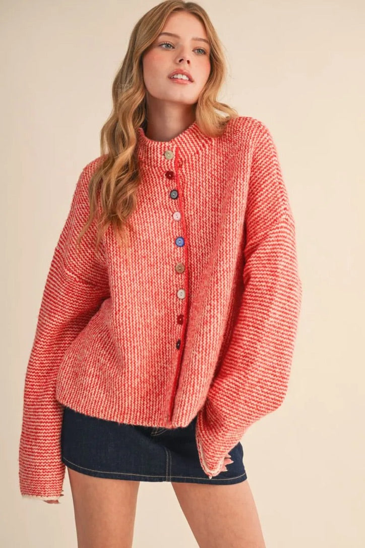 Trestles Clothing Company cozy red and white knit sweater featuring unique mismatched buttons and a relaxed fit.