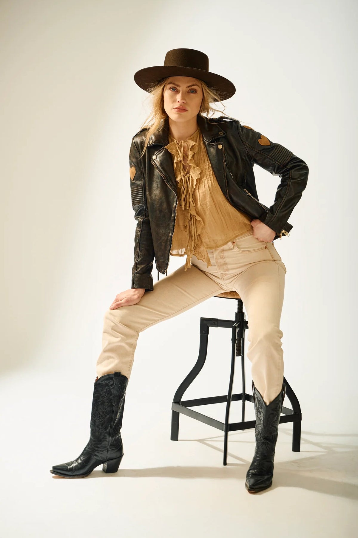 Model wearing Trestles Clothing Company Reo 2 black lambskin leather moto jacket with heart details on shoulders