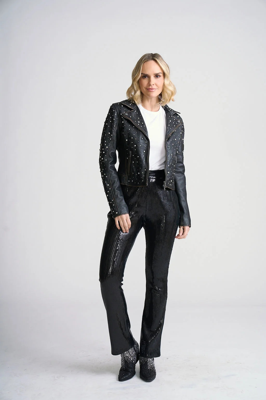 Model wearing Trestles Clothing Company Roxanne black lambskin leather jacket with silver stud embellishments