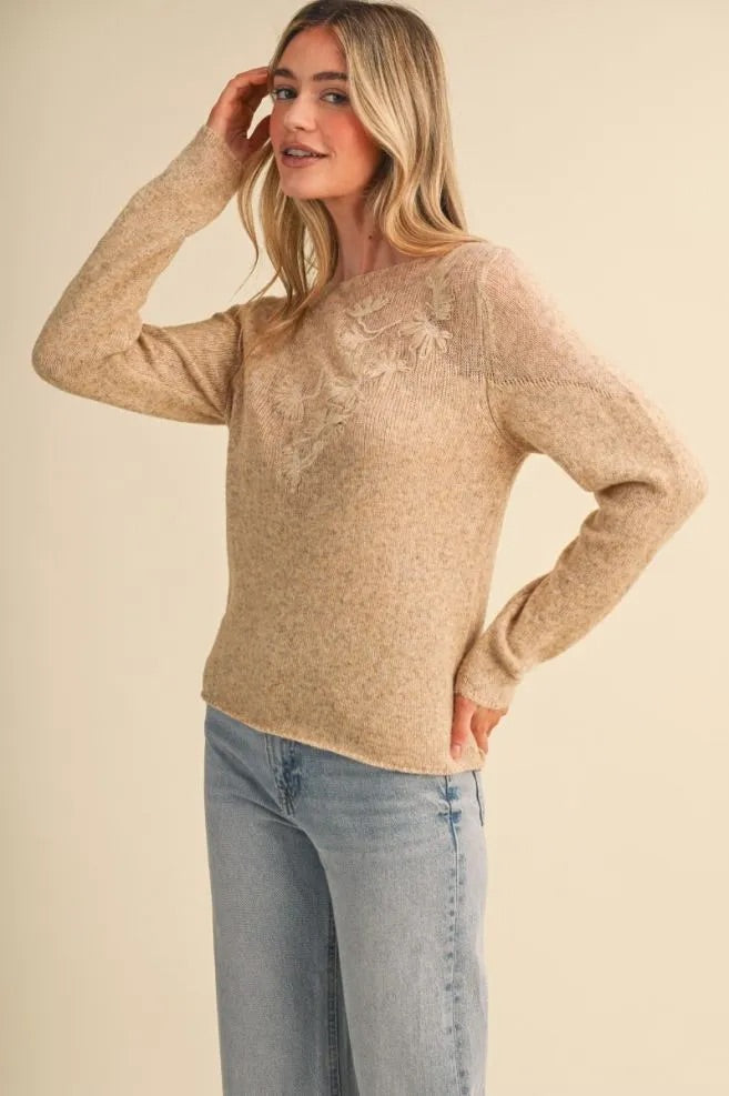 Trestles Clothing Company sheer beige knit sweater with tonal floral embroidery, boat neckline, and long sleeves.